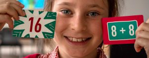 Child with doubling maths cards